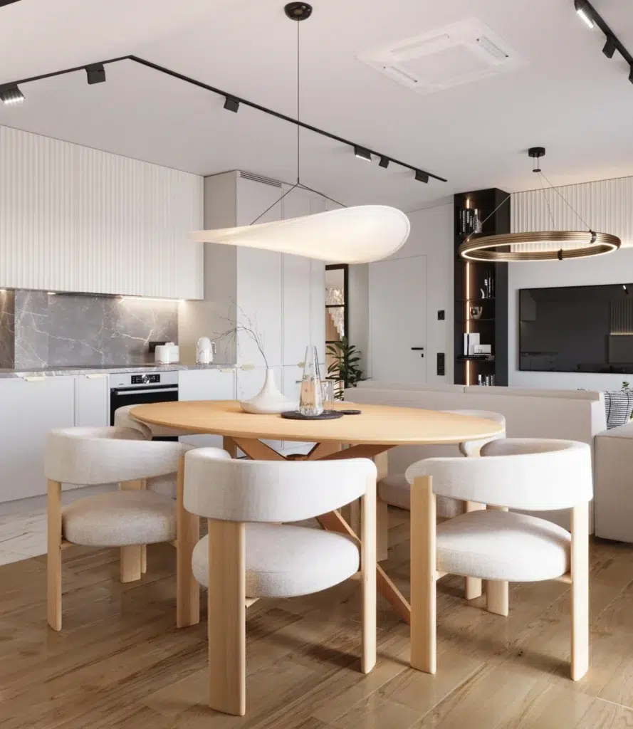 Nowoczesna jadalnia z okrągłym stołem i designerskimi krzesłami w jasnym, minimalistycznym wnętrzu kuchni