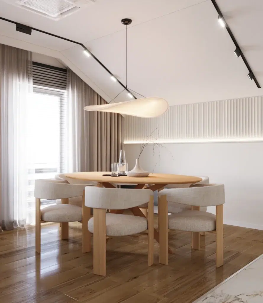 Nowoczesna jadalnia z okrągłym stołem i designerskimi krzesłami w jasnym, minimalistycznym wnętrzu kuchni